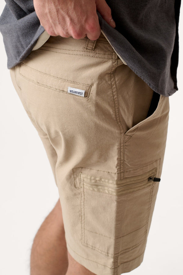 Male model dressed in tailored fit WEARFIRST Switchback Short with in Chinchilla Beige