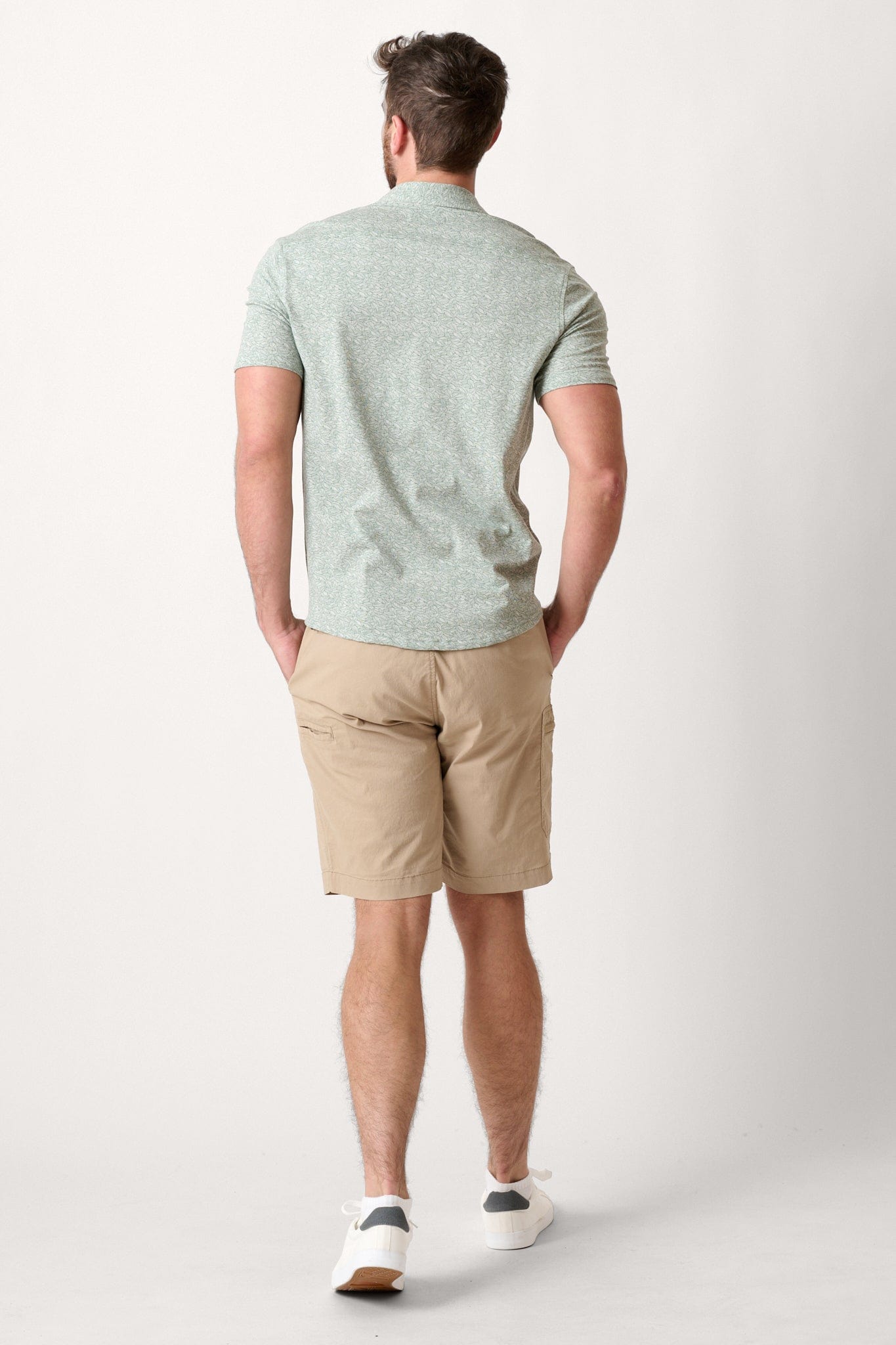 Male model dressed in casual men’s style with the WEARFIRST Venture Short in Chinchilla beige