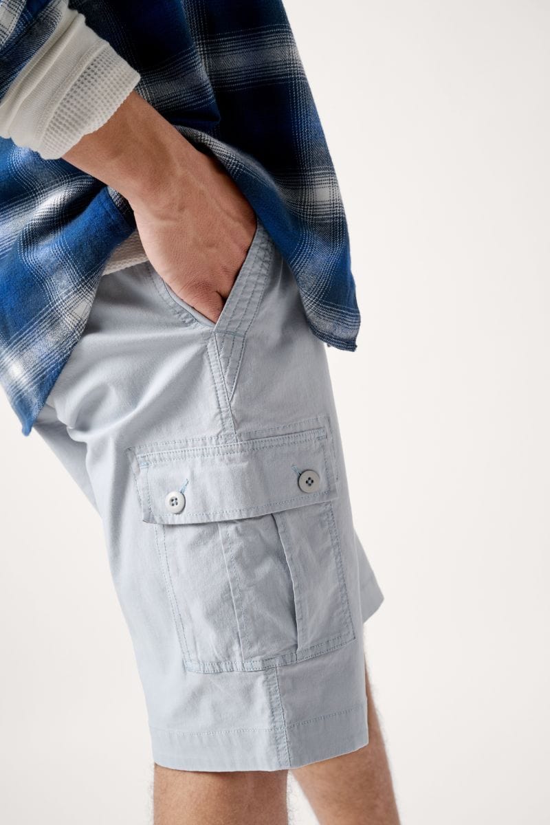 Male model dressed with the WEARFIRST Rambler Day Hiker Cargo Short in Bleached Blue