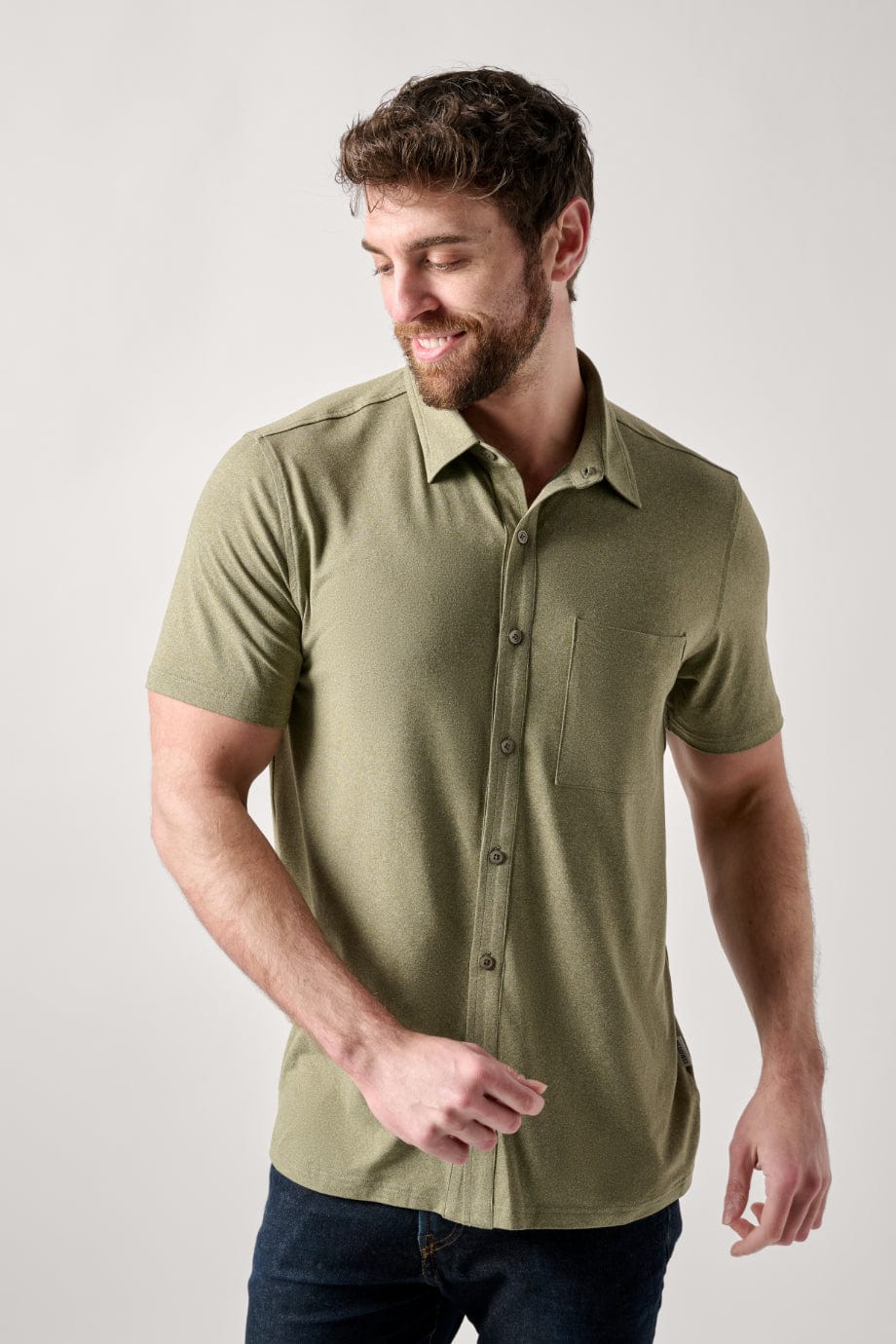Male dressed in casual style with the All Day Performance Shirt in Four Leaf Clover Heather
