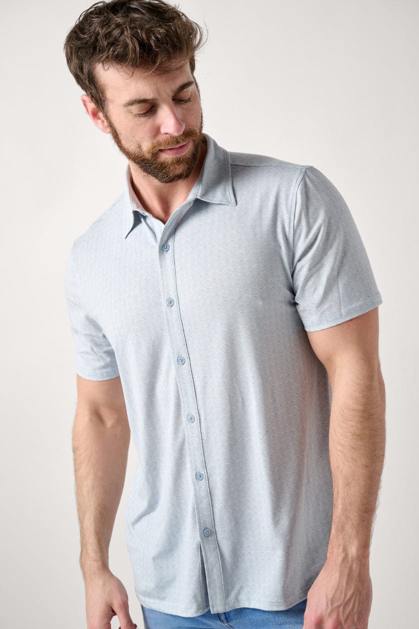 Male model dressed in men’s fitted shirt with the WEARFIRST Wanderer Shirt in Blue Fog Waves