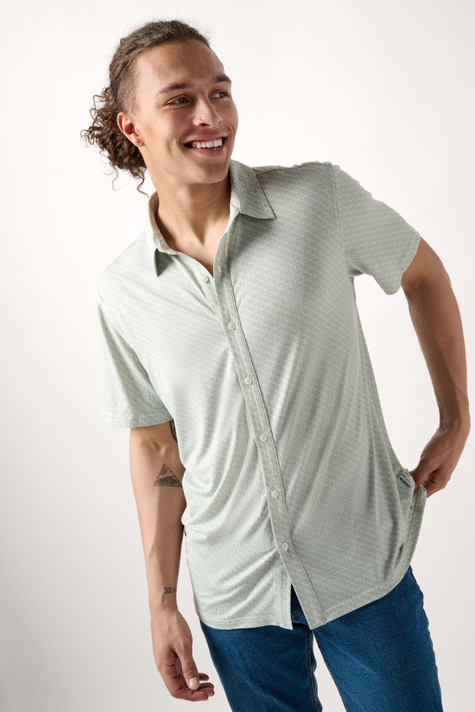 Male model dressed in men’s fitted shirt with the WEARFIRST Wanderer Shirt in Chinois Green Leaves