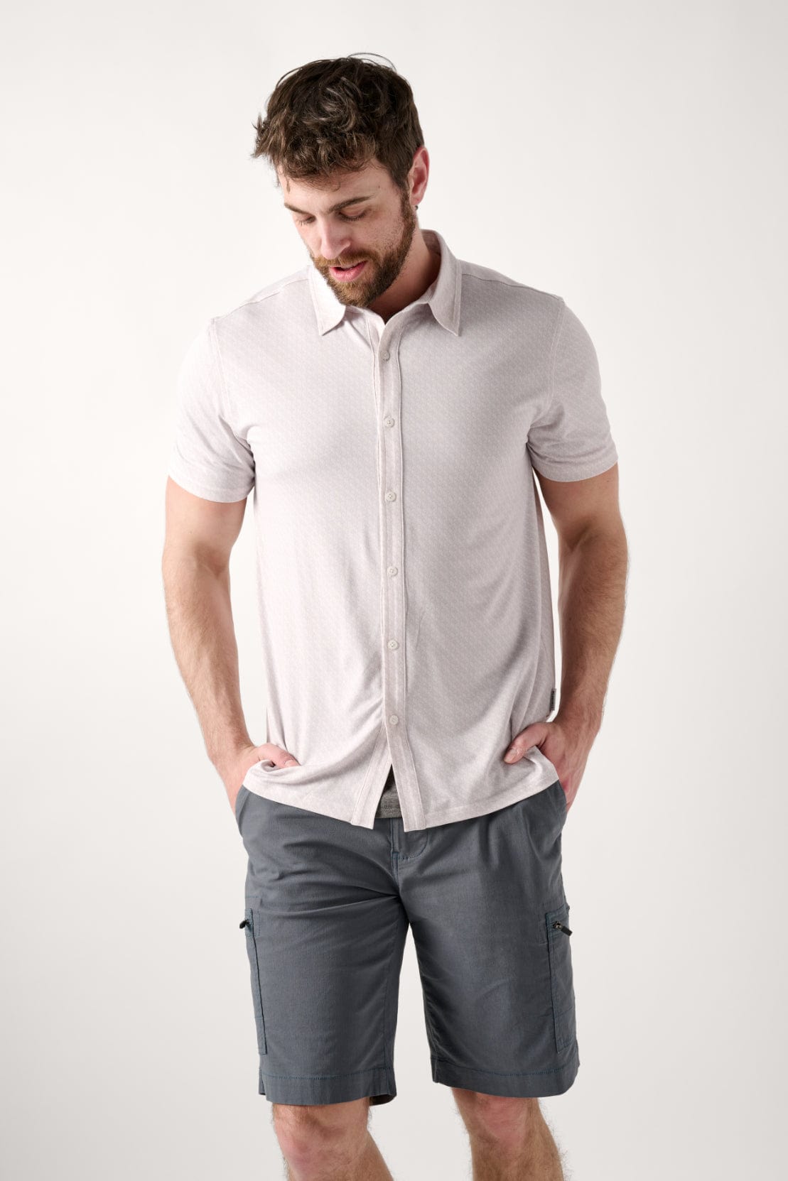 Male model dressed in men’s fitted shirt with the WEARFIRST Wanderer Shirt in Raindrops Leaves