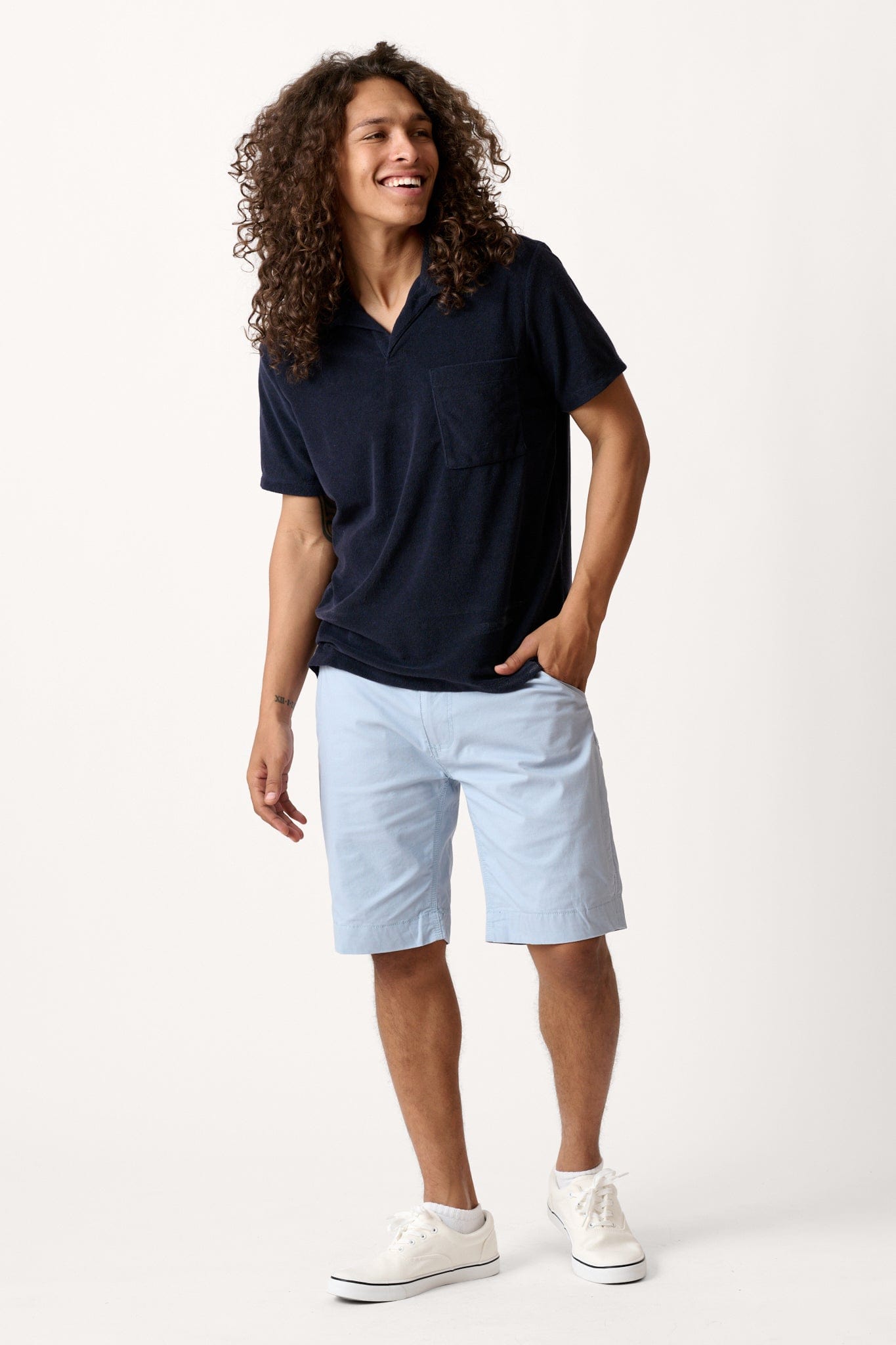 Male model dressed in tailored fit activewear with the WEARFIRST Hudson Cargo Short in Vetiver Green