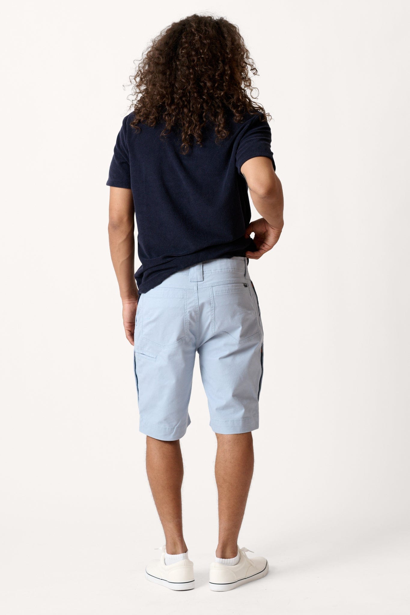 Male model dressed in tailored fit activewear with the WEARFIRST Hudson Cargo Short in blue fog