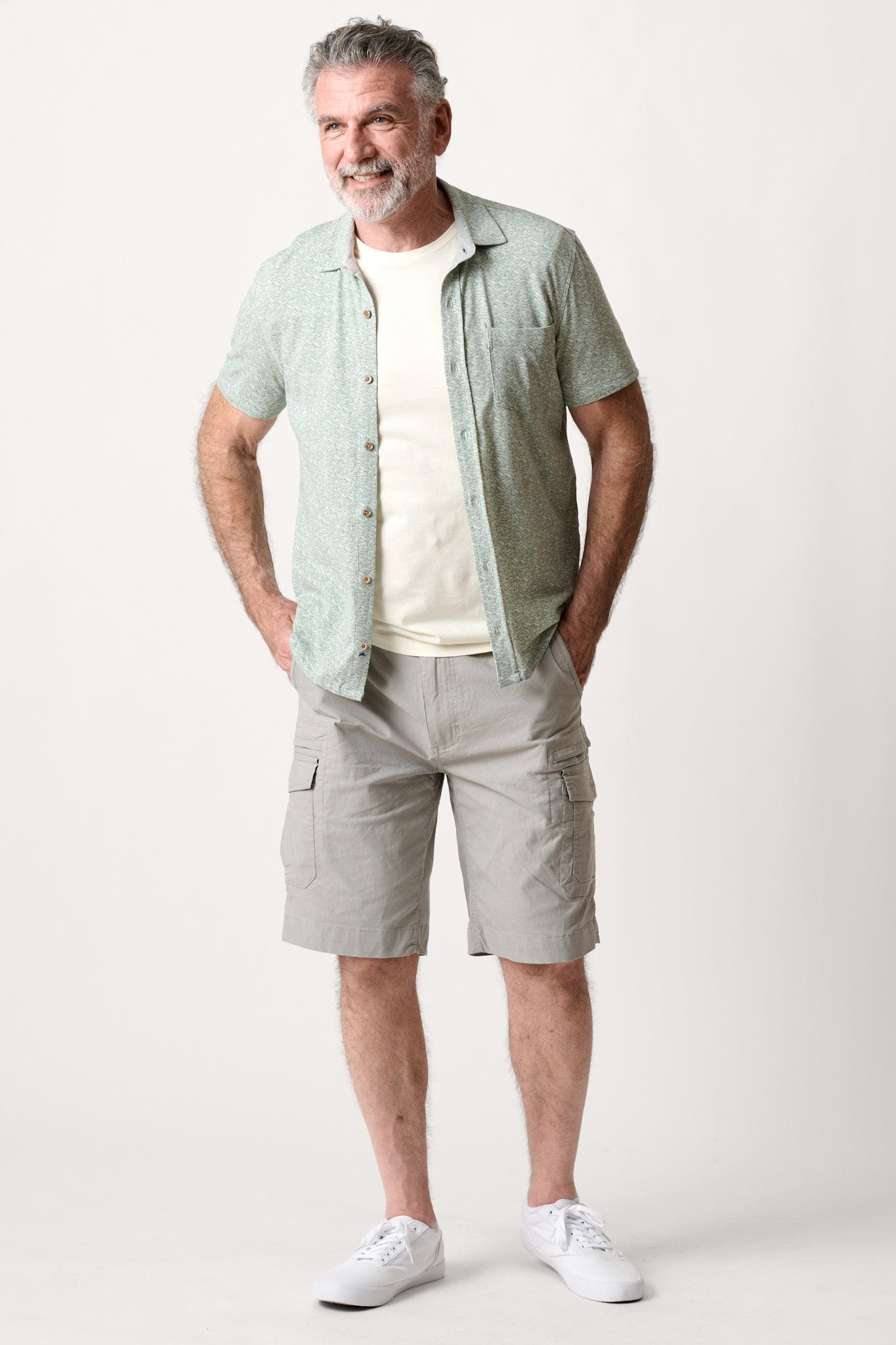 Male model dressed in hiking shorts for men with the WEARFIRST Wayfarer Cargo Short in Neutral Gray