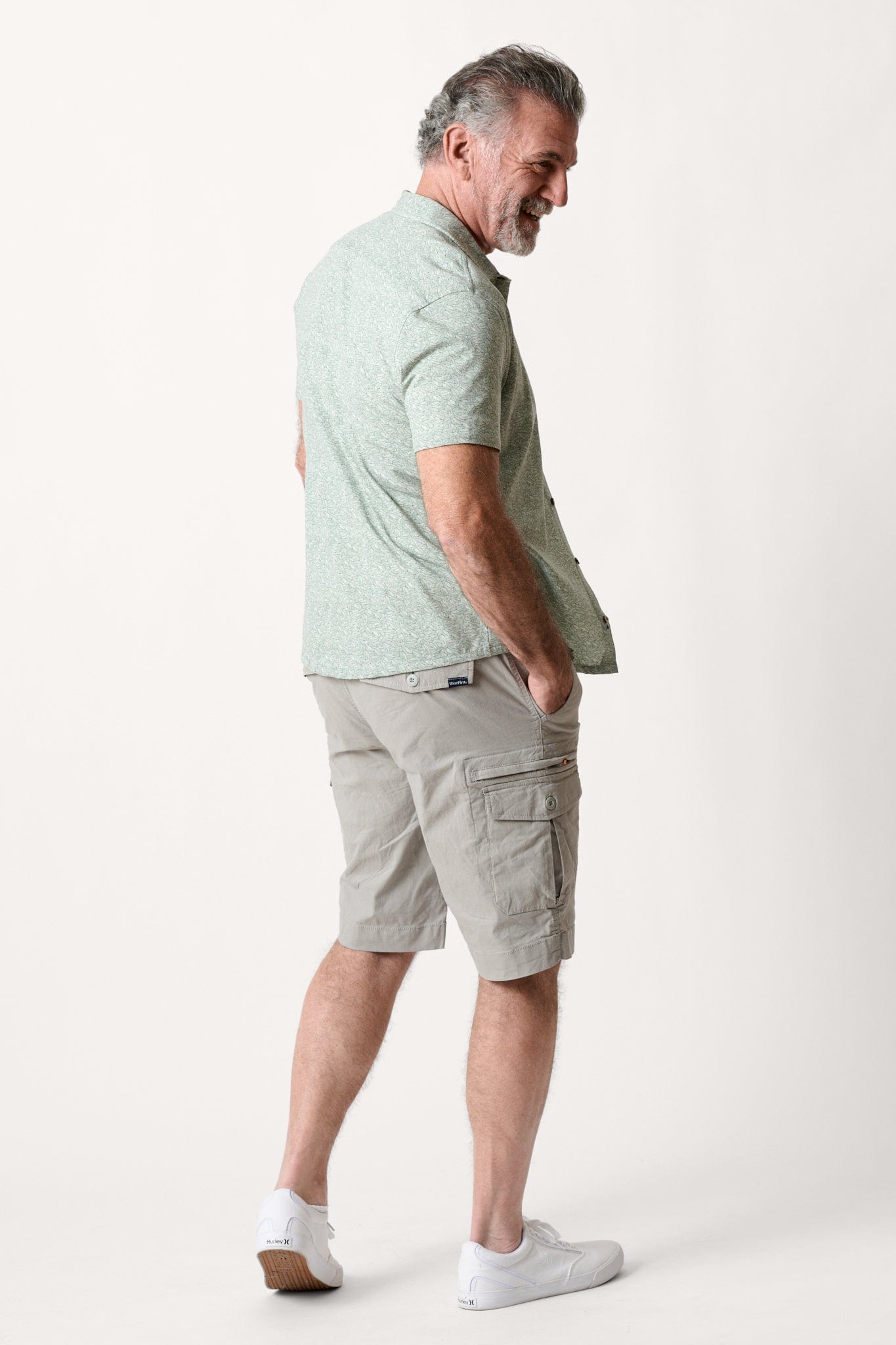 Male model dressed in hiking shorts for men with the WEARFIRST Wayfarer Cargo Short in Neutral Gray