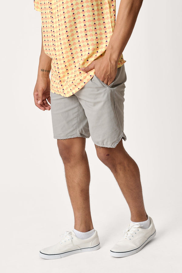 Male model dressed in men’s lightweight shorts with the WEARFIRST Volley Short in Neutral Gray