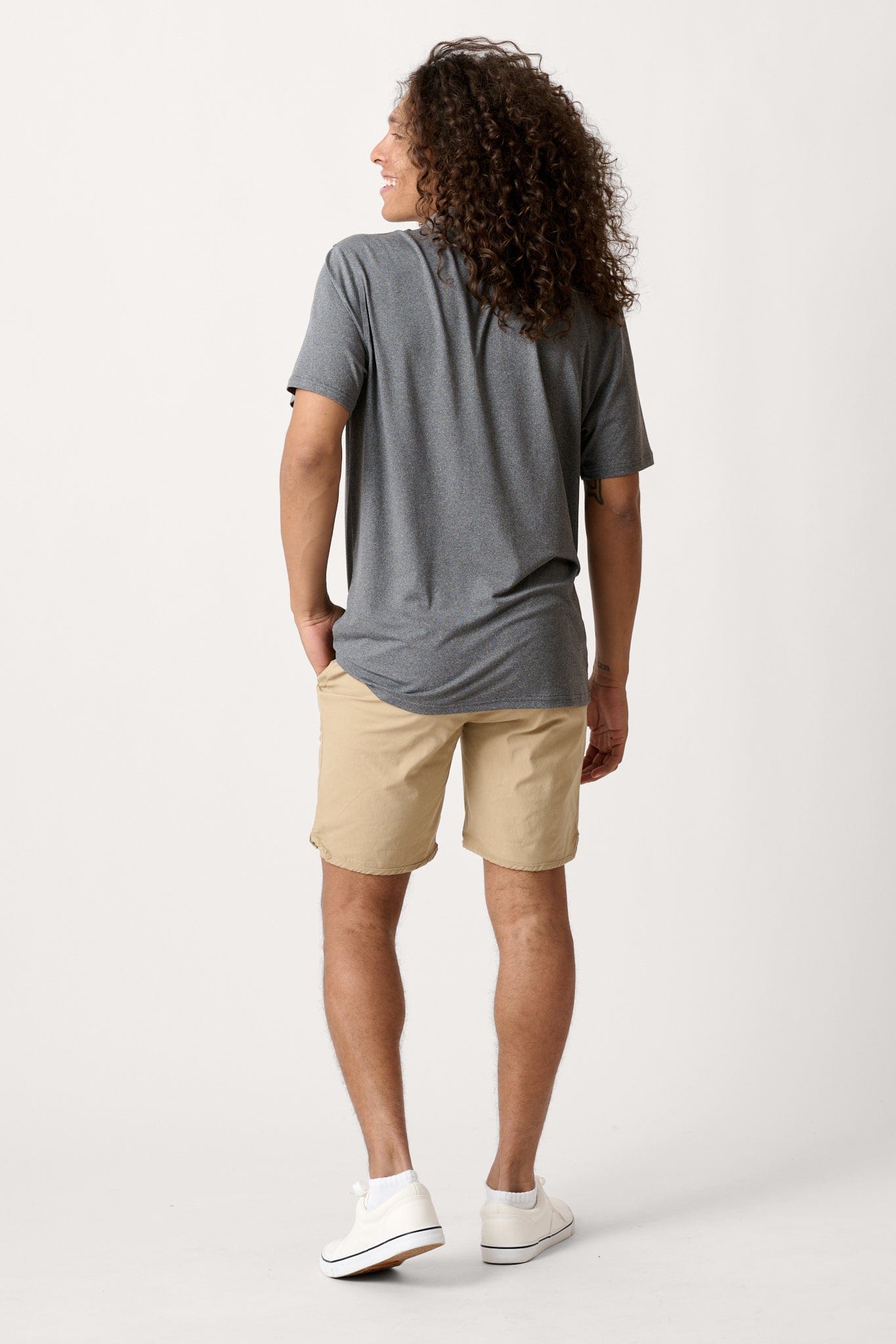 Male model dressed in men’s lightweight shorts with the WEARFIRST Volley Short in Twill Beige