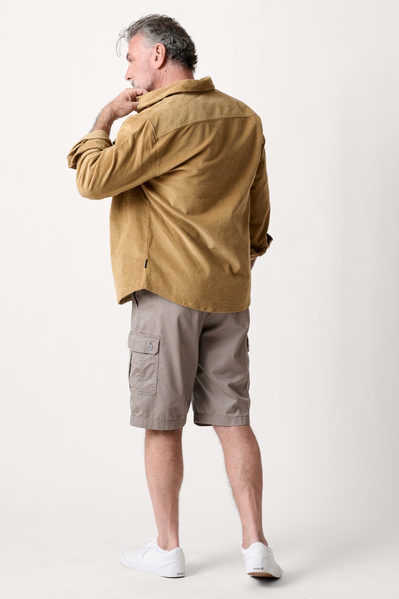 Male model dressed in casual men’s style with the WEARFIRST Stretch Corduroy Shirt Jacket in khaki