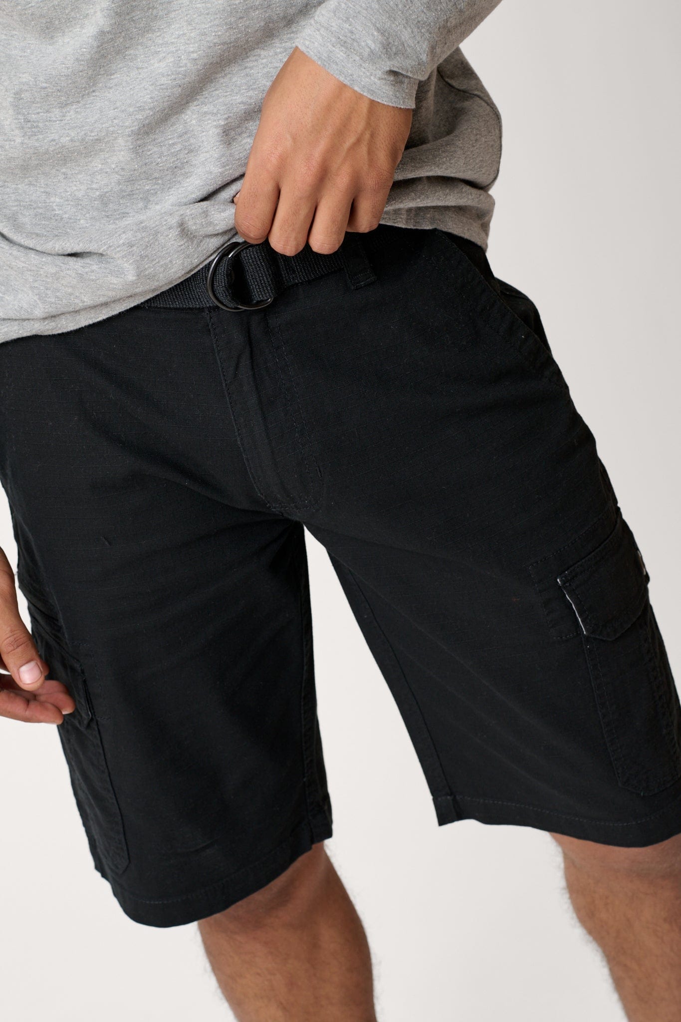 Male model dressed in men’s ripstop cargo shorts with the WEARFIRST Stretch Cargo Short in Black